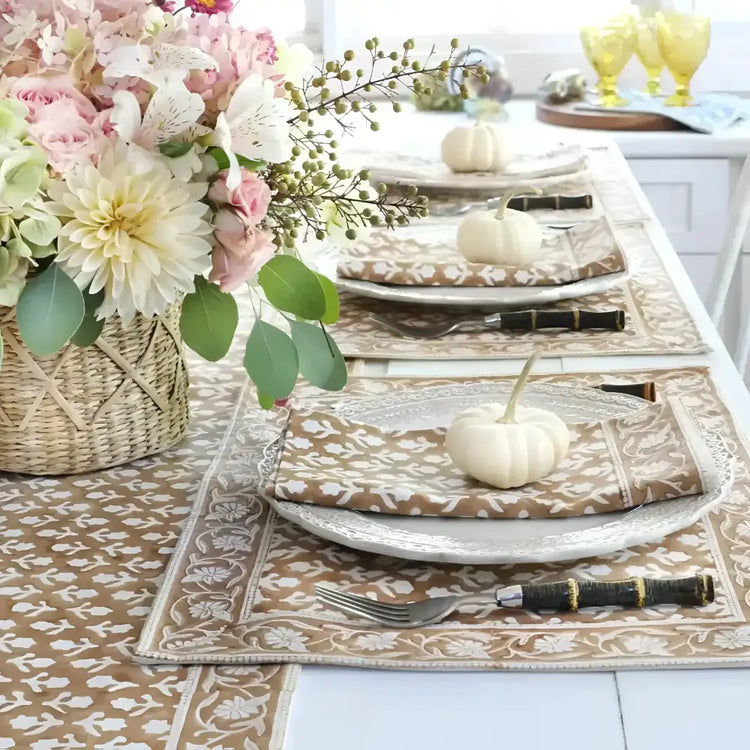 Dining table with Caramel Block Print Table Linens, white pumpkins, and floral centerpiece