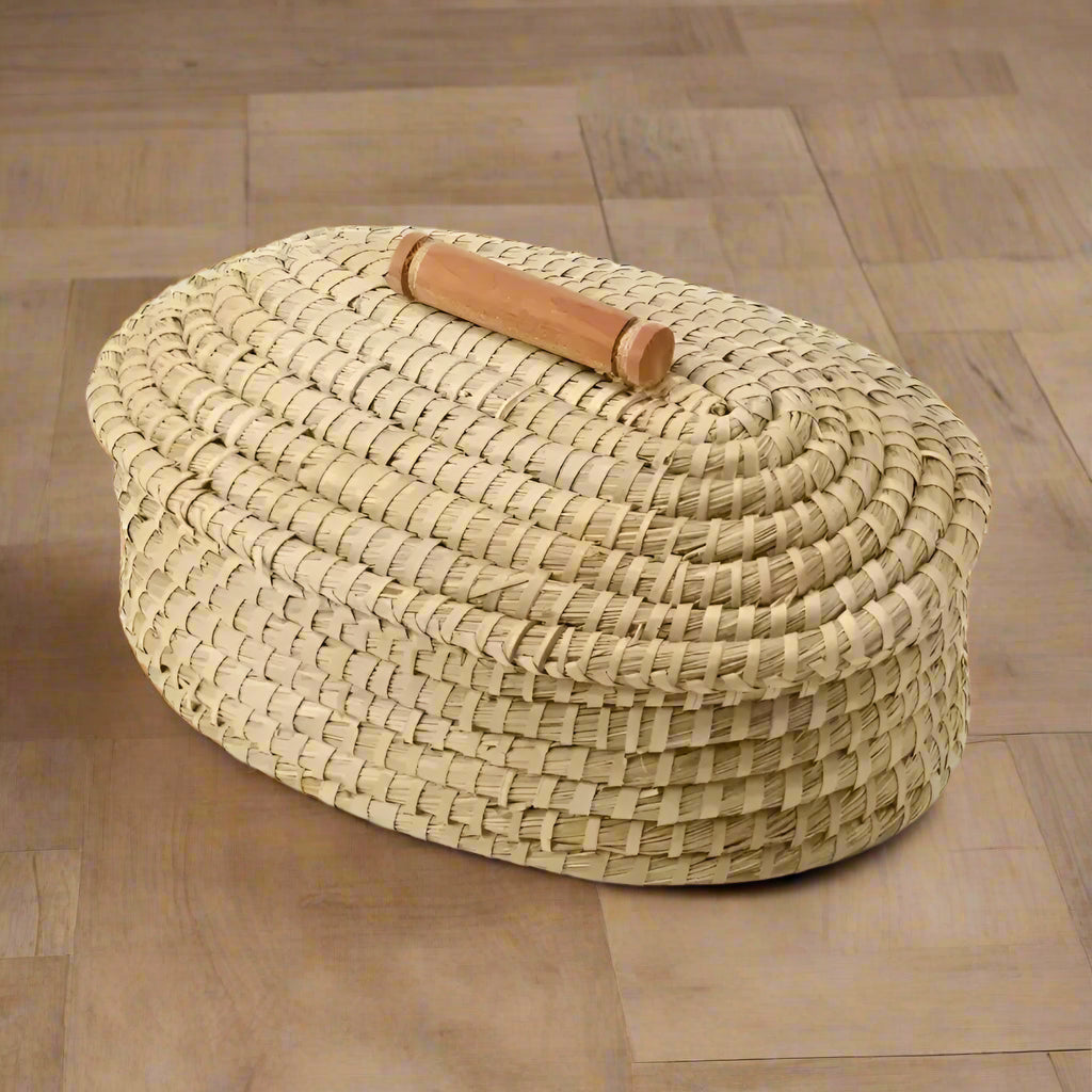 Oval handmade straw bread warming basket with wooden handle from Butterfly Garden