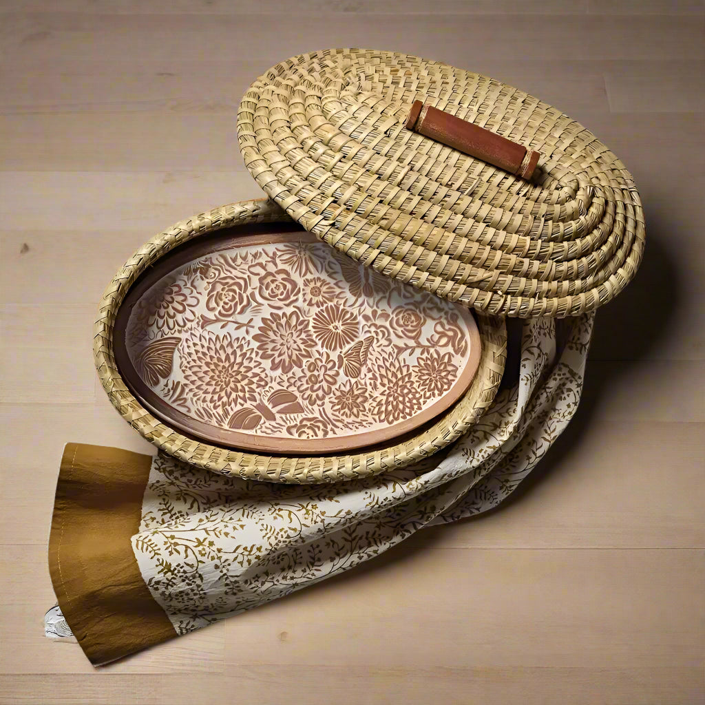 Woven straw bread warming basket with floral tray and fabric liner for cozy picnics