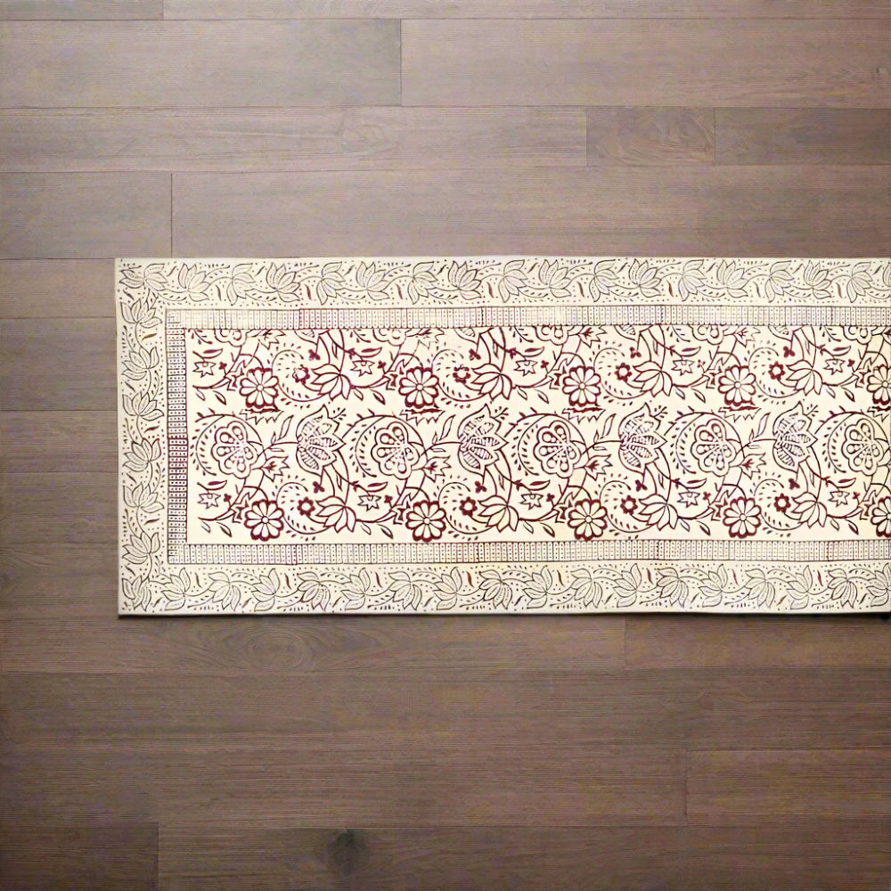 Red and white Vine Block Print Table Runner on a dark wooden surface
