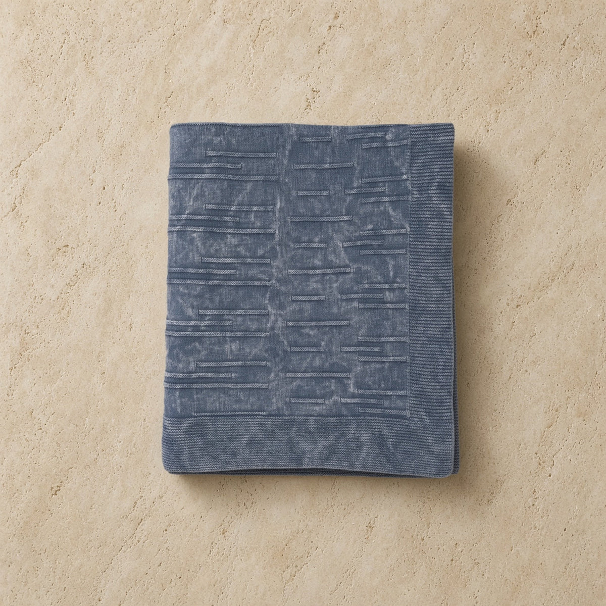 A soft slate-blue flintstone lines throw with ribbed edges in washed cotton perfect for cozying up