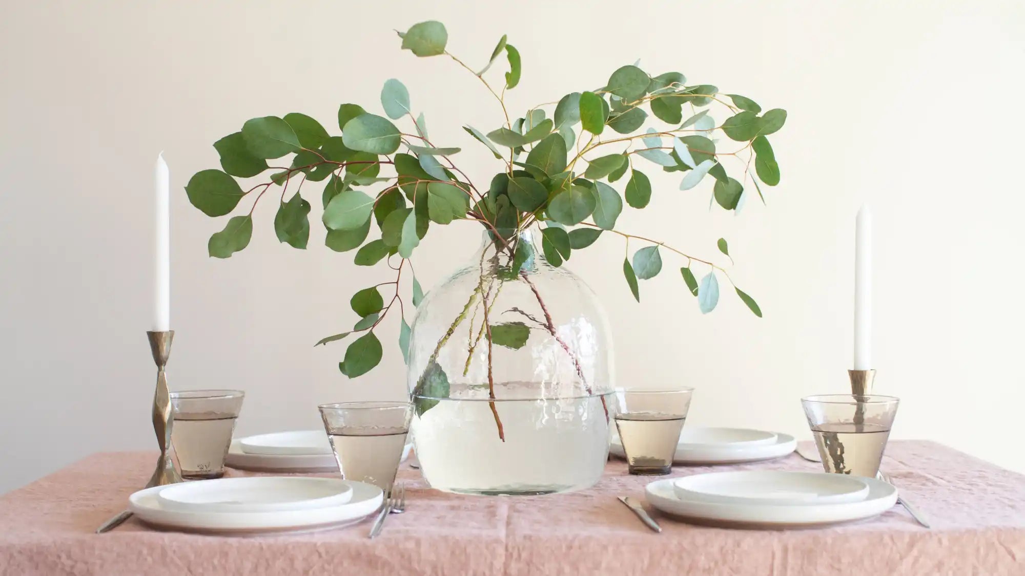 Handblown hammered glass vase in clear on light background.