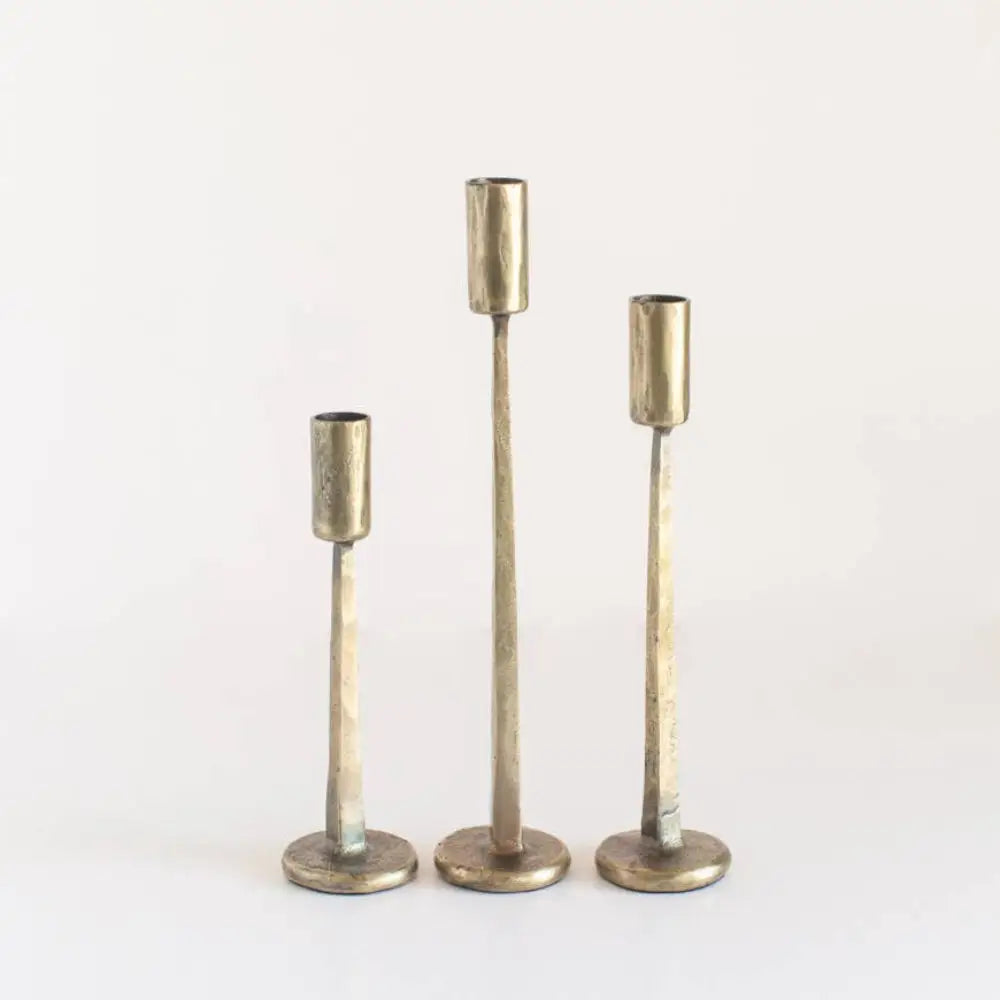 Hand Forged Iron Candle Stands set of three in brass on a light background