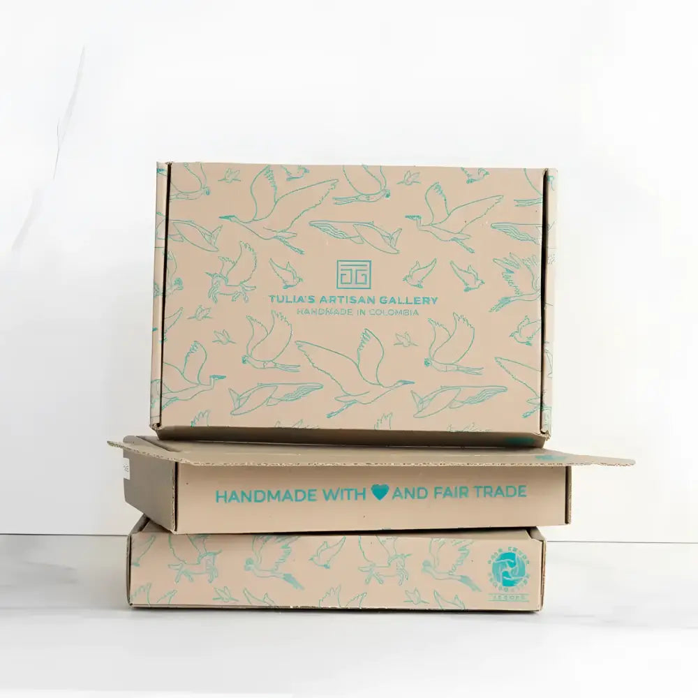 Stack of three beige cardboard boxes with light blue bird illustrations for a perfectly balanced playful flutter cardinal mobile