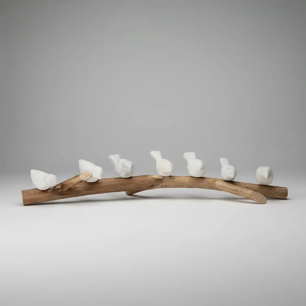 Handcrafted eco-friendly ceramic bird figurines on wooden branch for home decor