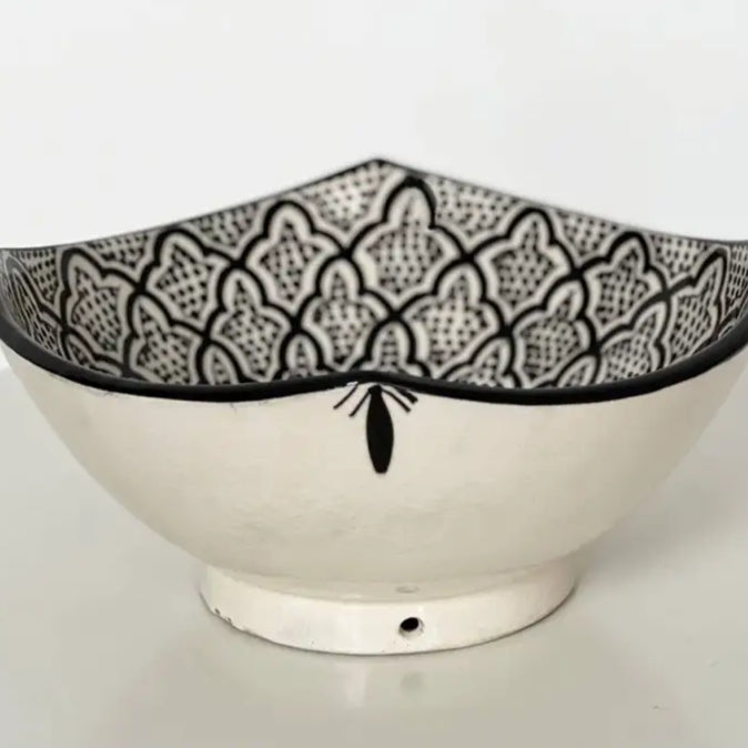 White handcrafted ceramic bowl with black geometric rim from Safi Morocco, an industrial port town on the rugged Atlantic coast
