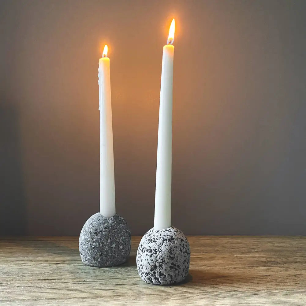 Handmade eco-friendly ceramic candleholder with gray speckled stone base and white taper candles