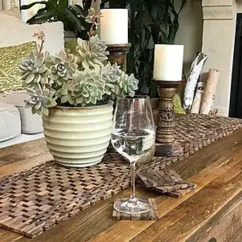 Potted succulent plant arrangement on a handcrafted Rosewood Table Runner on a rosewood table