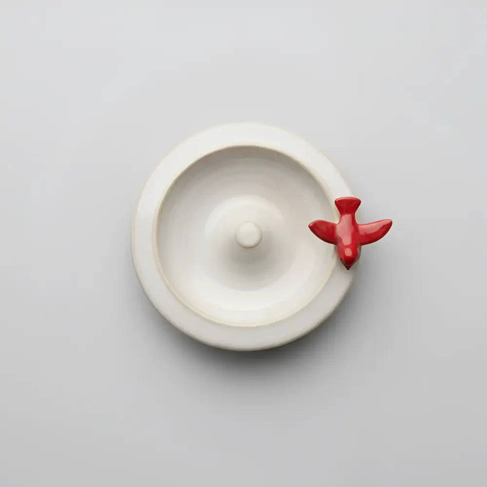 Handmade ceramic ring dish with perched red bird airplane hook