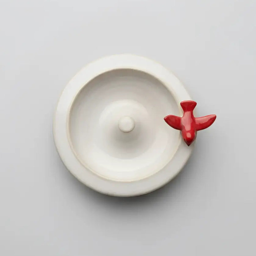 Handmade ceramic ring dish with perched red bird airplane hook