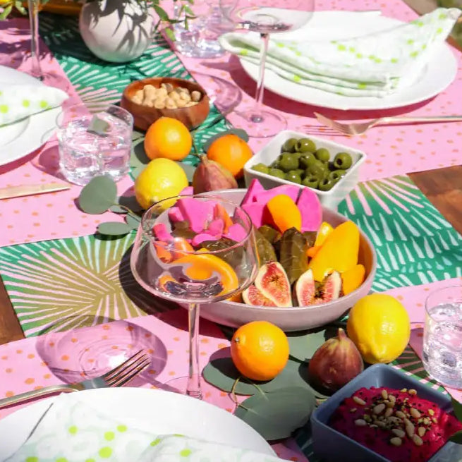Vibrant outdoor meal with handmade eco-friendly green and pink patterned linen table runner