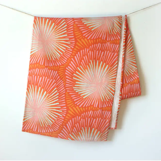 Handmade eco-friendly orange and pink patterned linen table runner with sunburst design