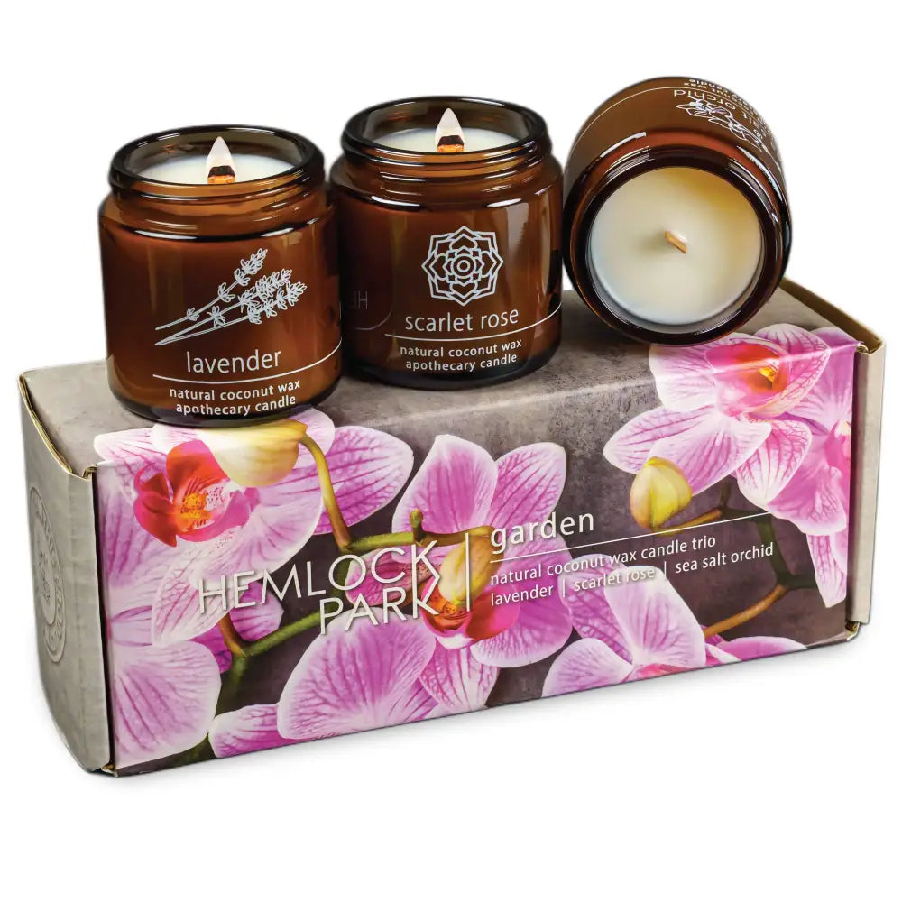 Scented candles with burning wicks in a sea salt orchid gift box, perfect for gifting
