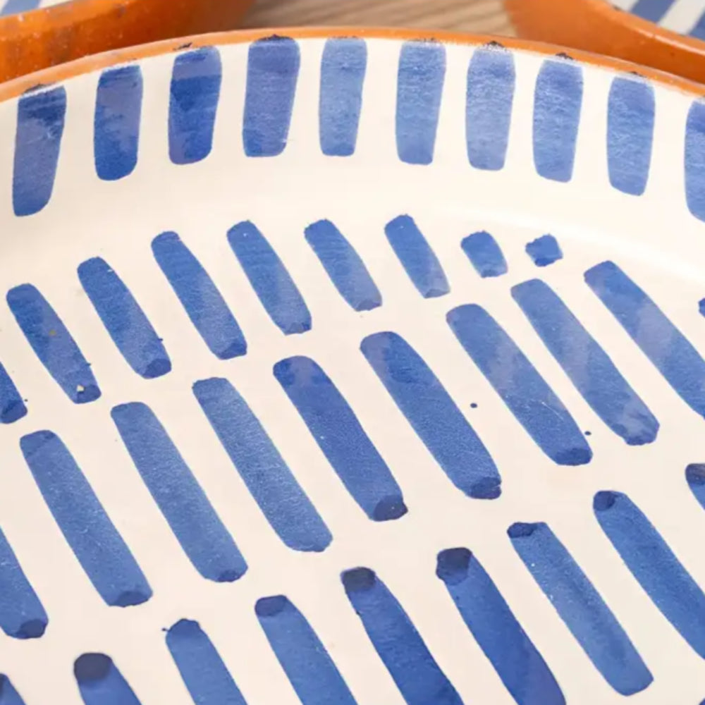 White ceramic plate with hand-painted blue dash patterns from handmade Moroccan ceramic nesting bowls set