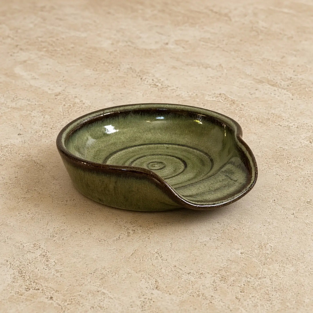 Handmade olive-green ceramic spoon rest with glossy glaze and subtle swirls perfect for spoon rest or tea strainer use