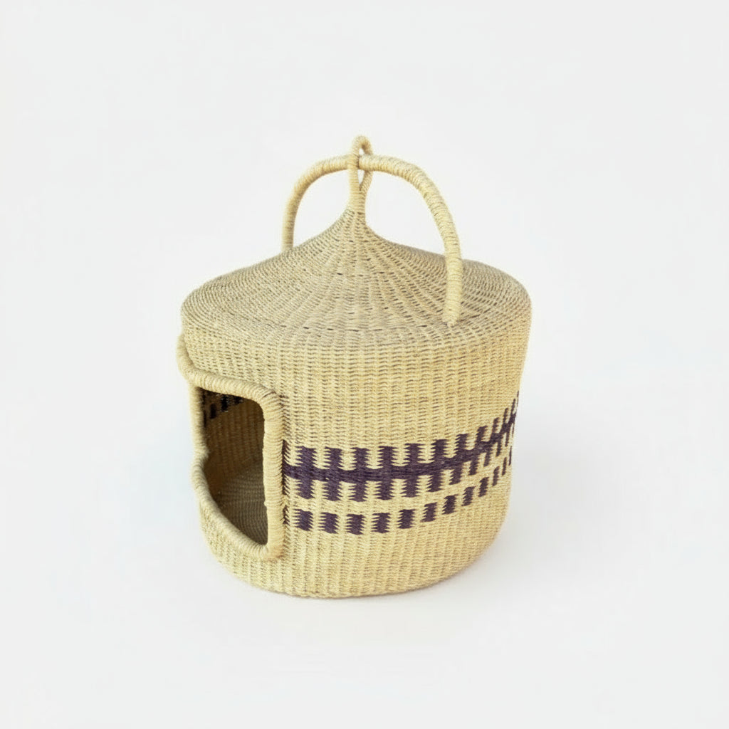 Handwoven straw cat bed basket with dark geometric pattern and carrying handles