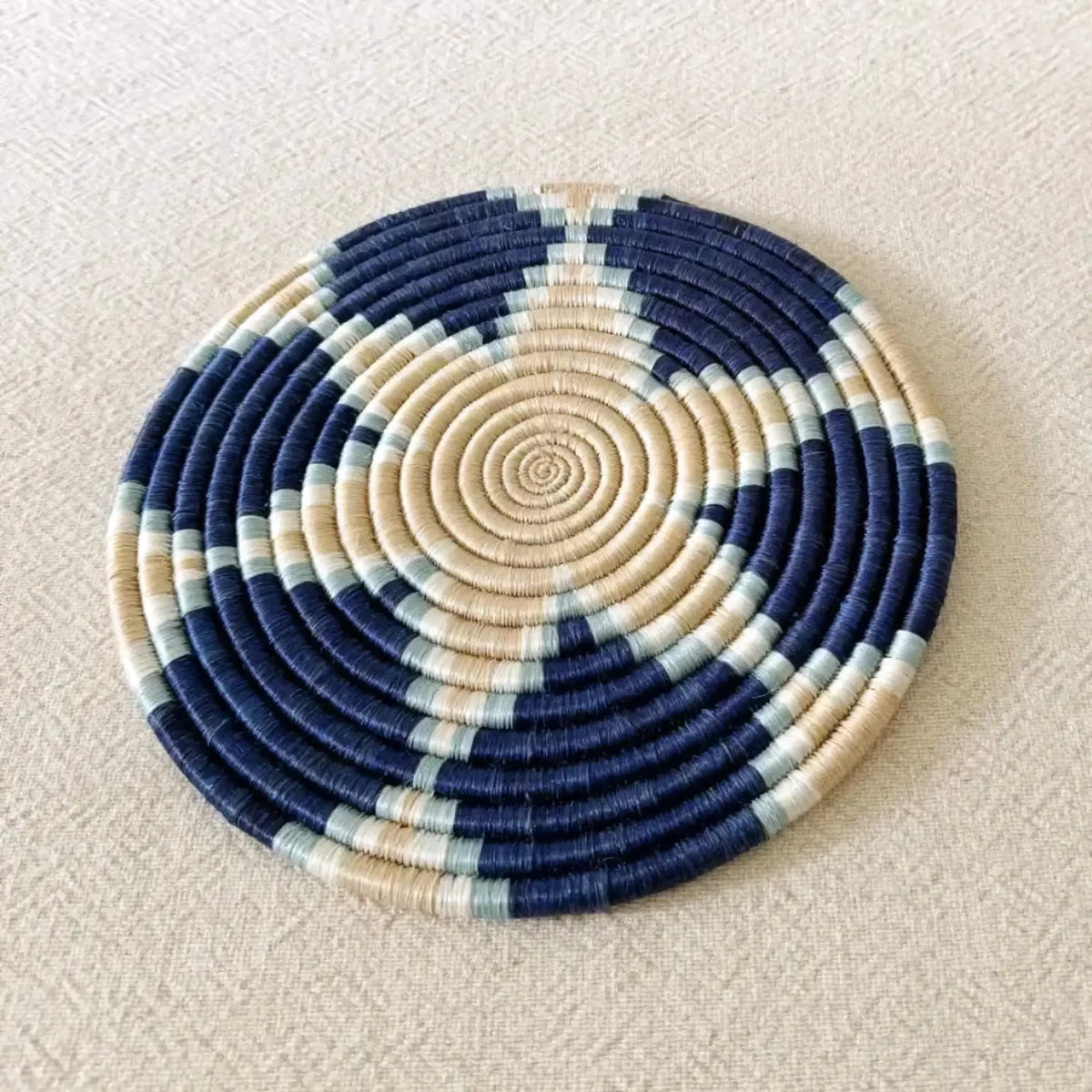 Handwoven african sisal trivet with circular navy blue beige and light gray rings perfect sisal trivet for decor