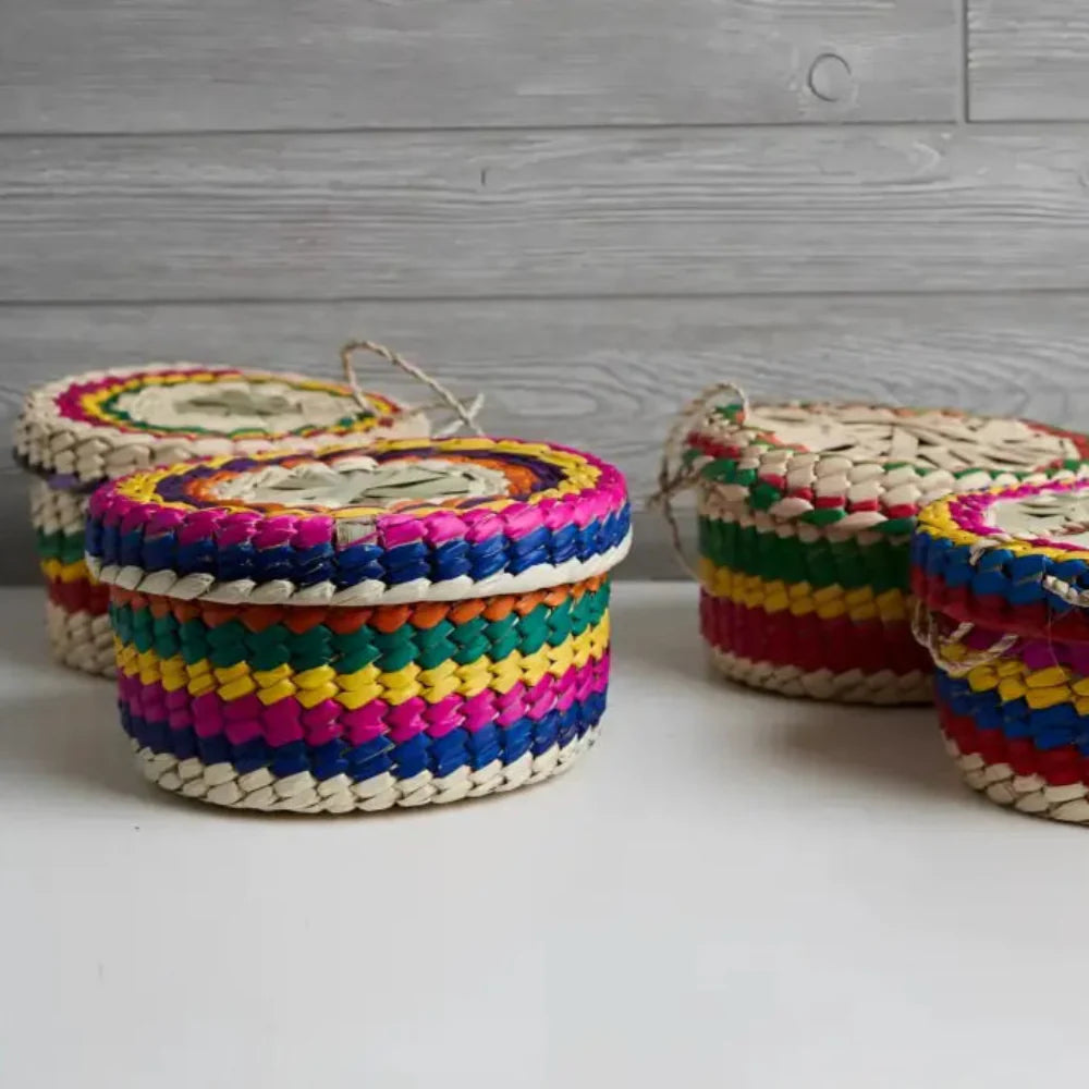 Four colorful baskets on a white surface