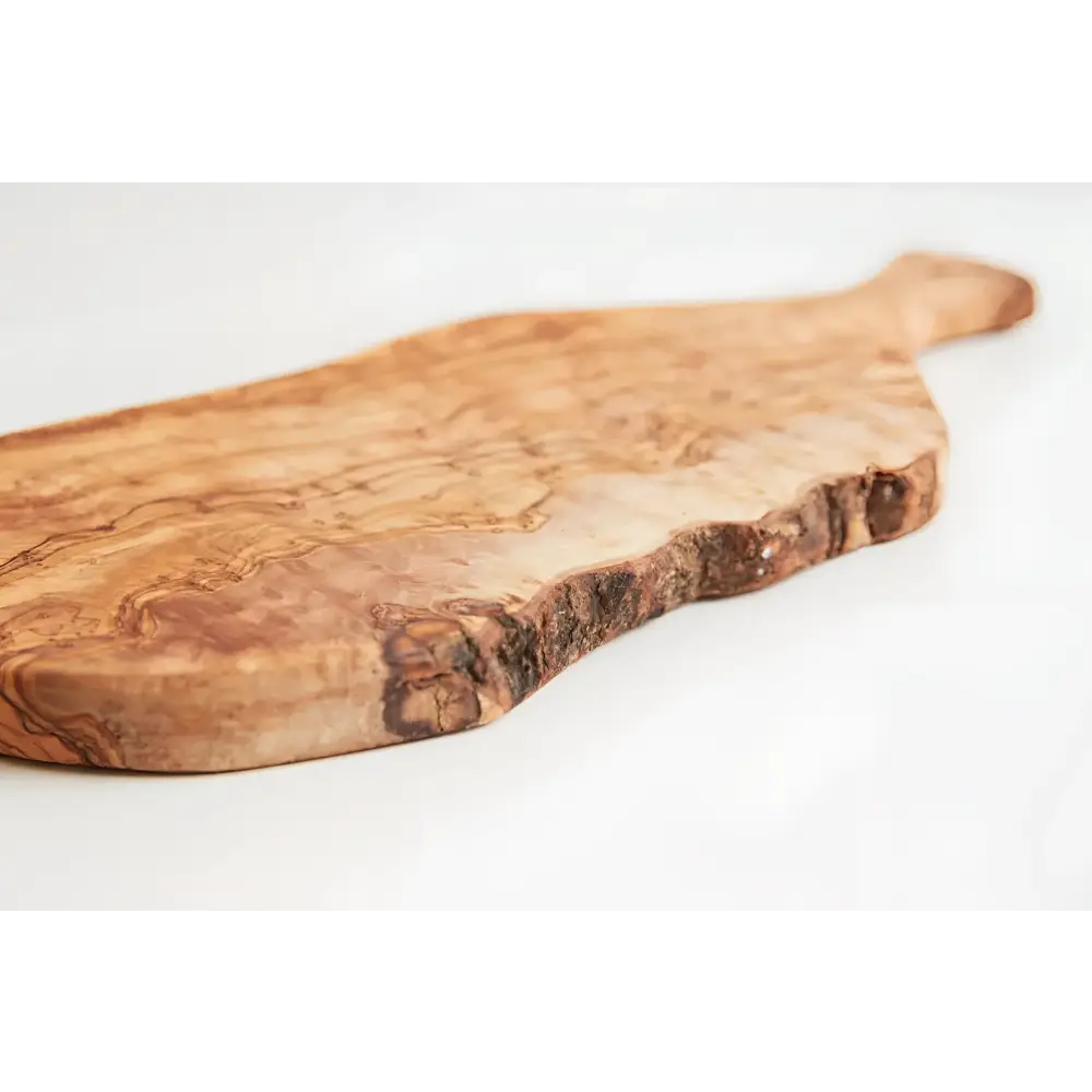 Olivewood cutting paddle board on a white surface