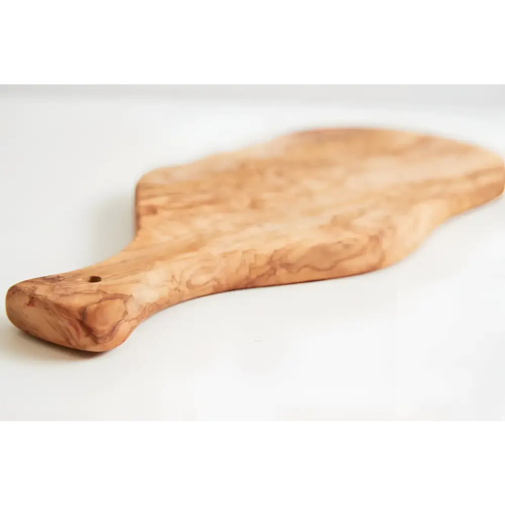 Olivewood cutting paddle board on a white surface