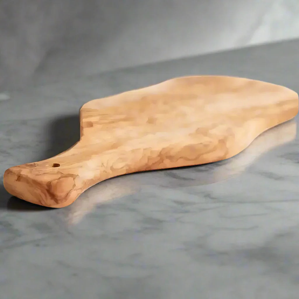 Light brown Italian Olivewood cutting board with bark edge and paddle handle