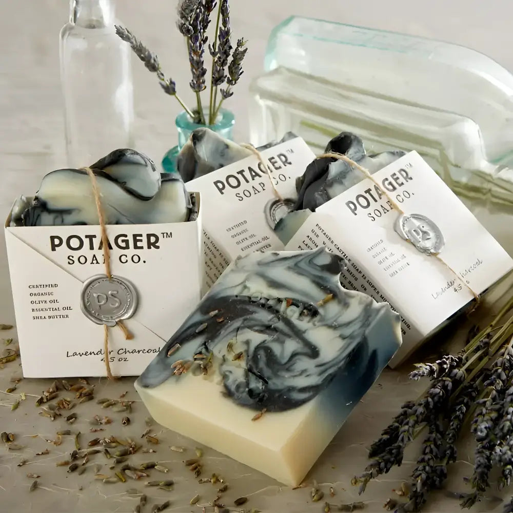 Four Lavender Charcoal Wrapped on a counter with lavender sprigs