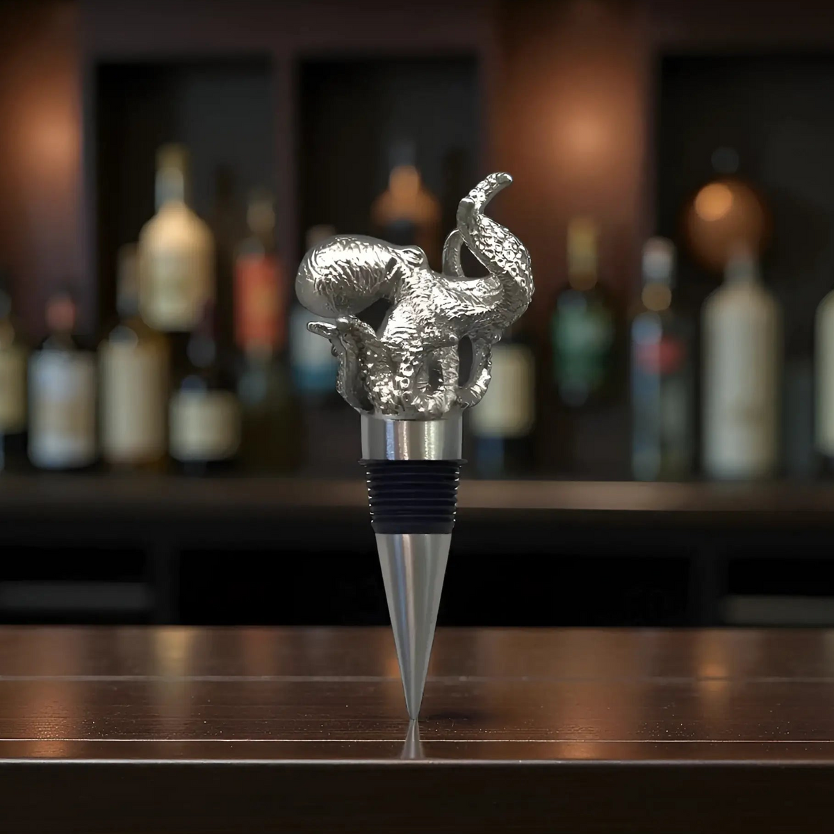 Silver pewter octopus bottle stopper with handmade textured sculpture and sleek metallic cone base for wine bottles