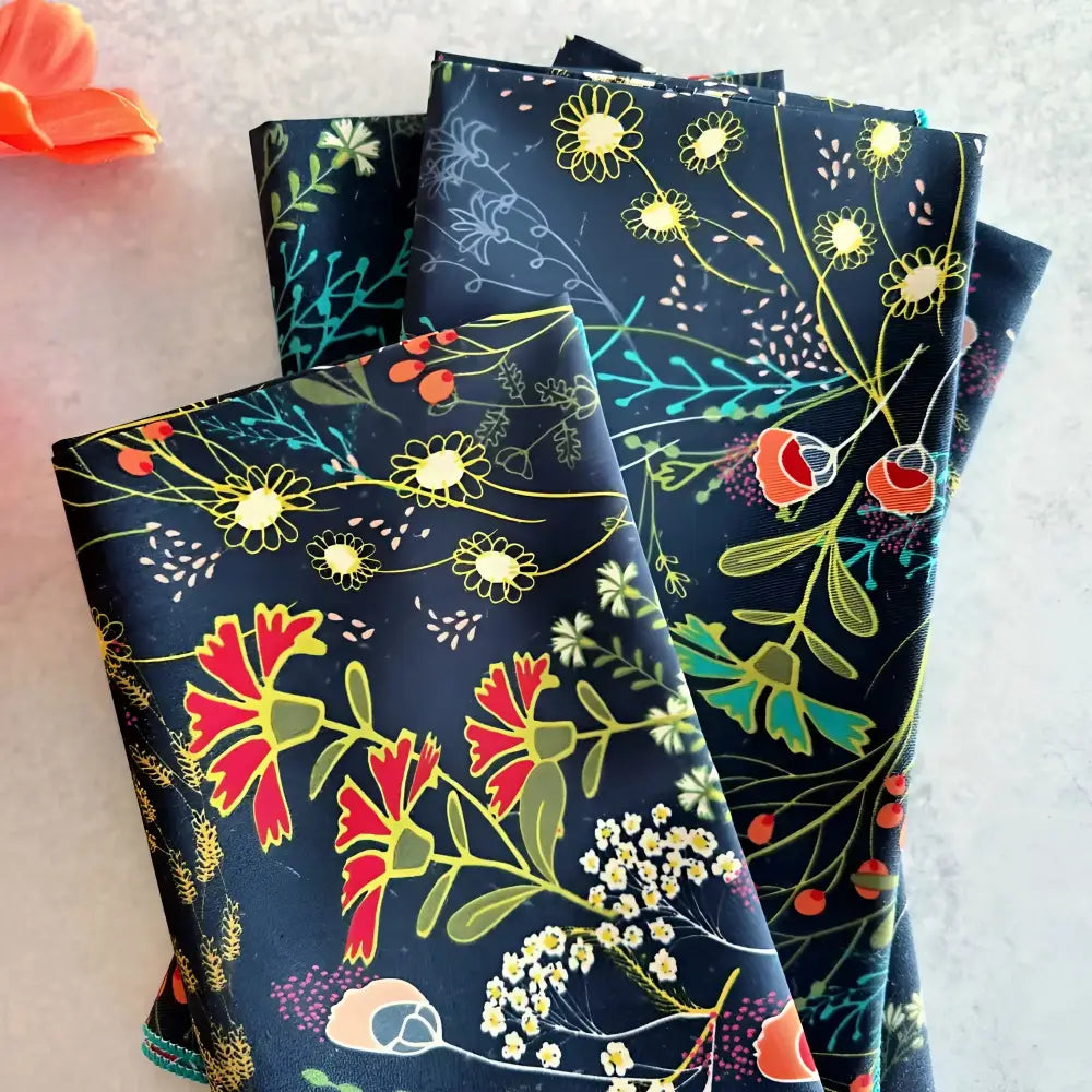 Stack of pretty peacock cloth napkins with colorful floral pattern for stylish table setting