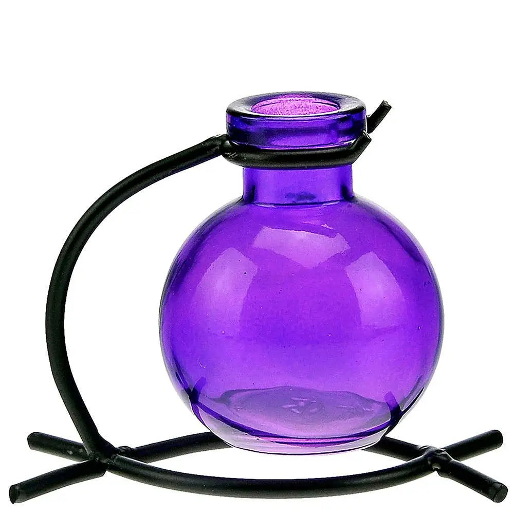 Purple recycled glass mini vase with black metal stand holding pink flowers