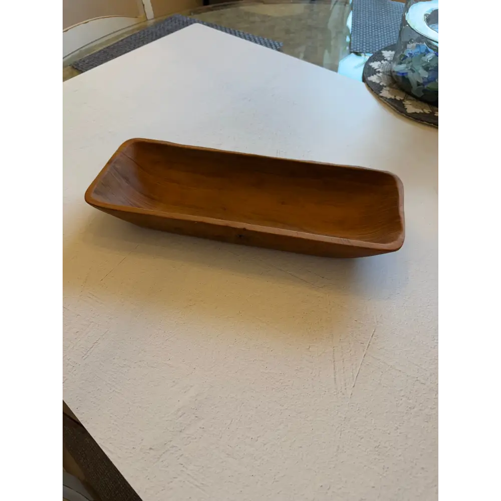 Rectangular salvaged teak root hand carved wooden oblong bowl with smooth warm brown finish perfect for bread bowls