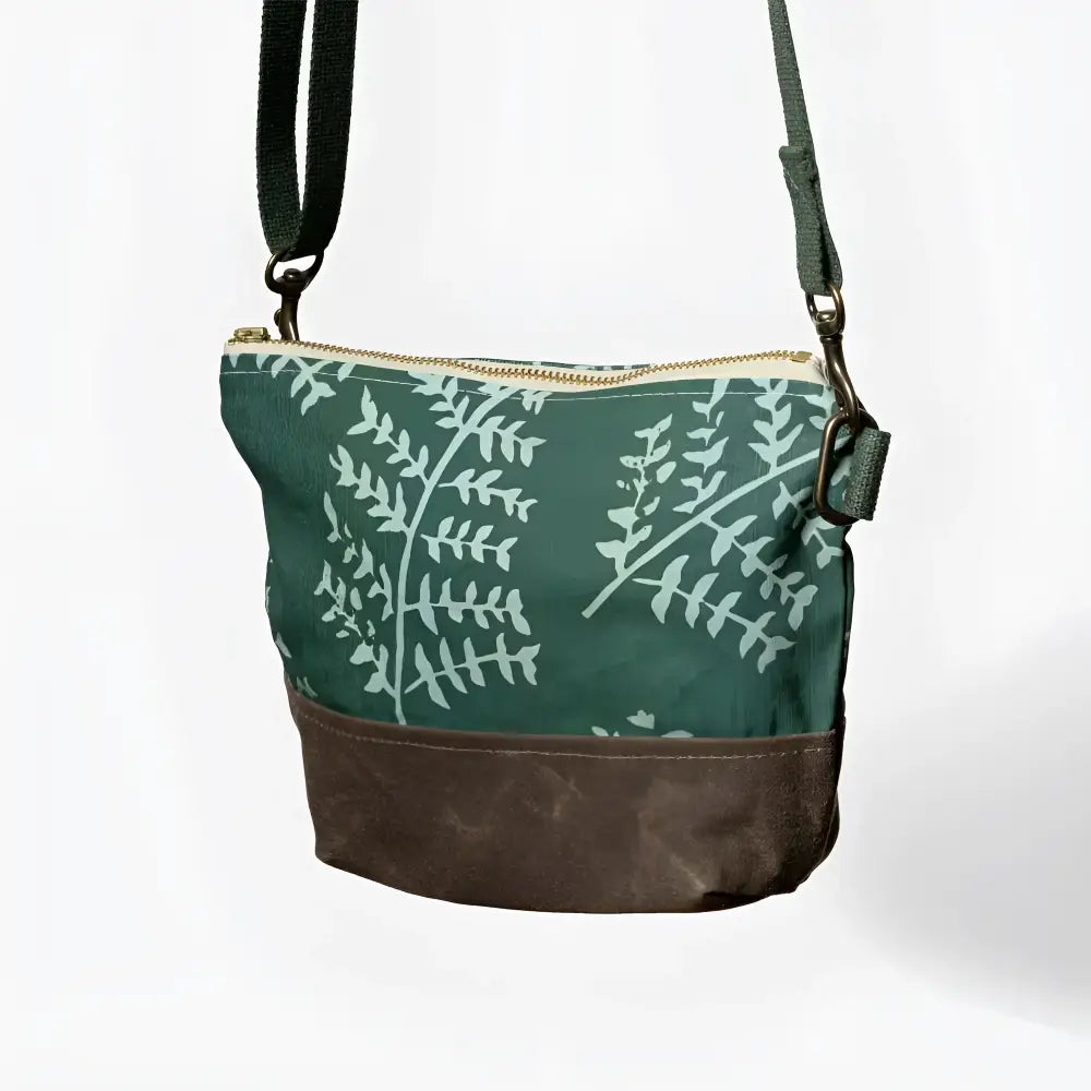 Small crossbody bag in dark green canvas with light mint fern print and brown waxed leather bottom