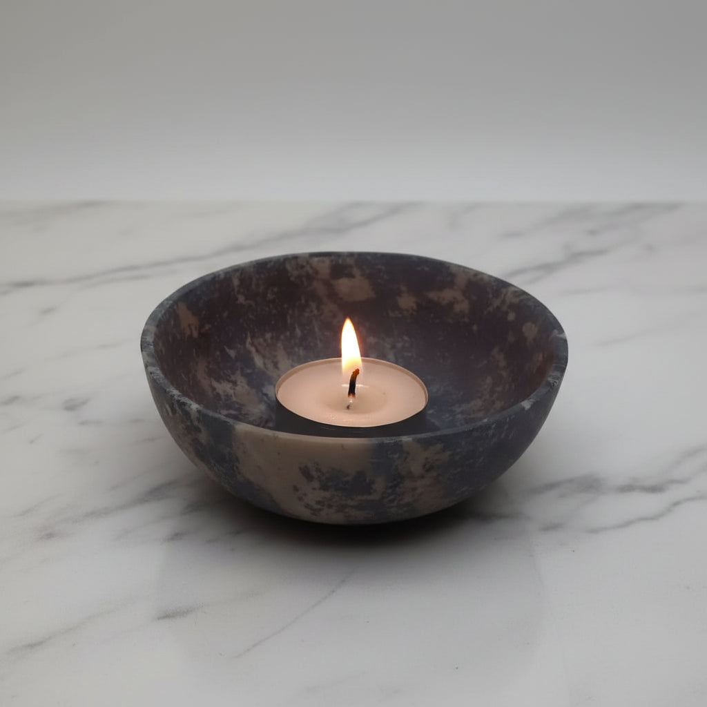 Lit handmade soapstone bowl with tea light candle