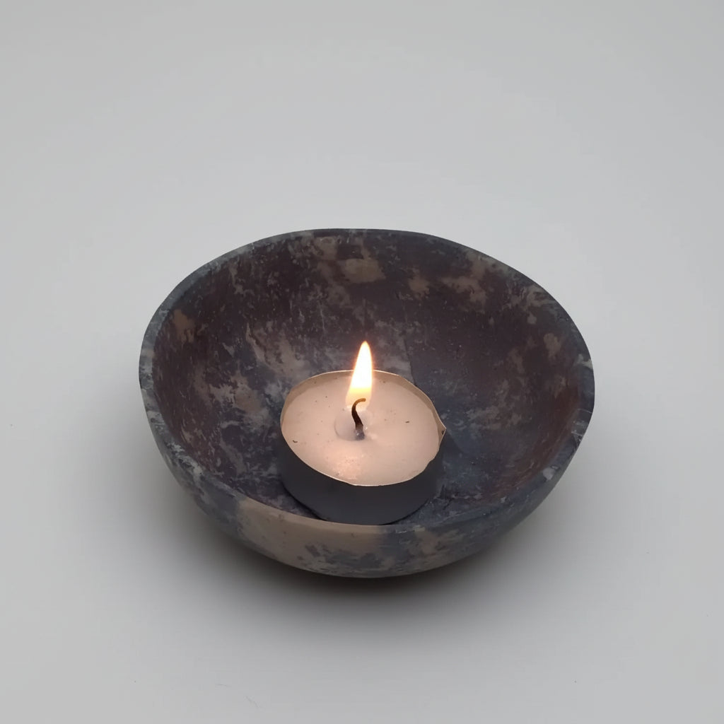 Lit handmade soapstone bowl with tea light candle