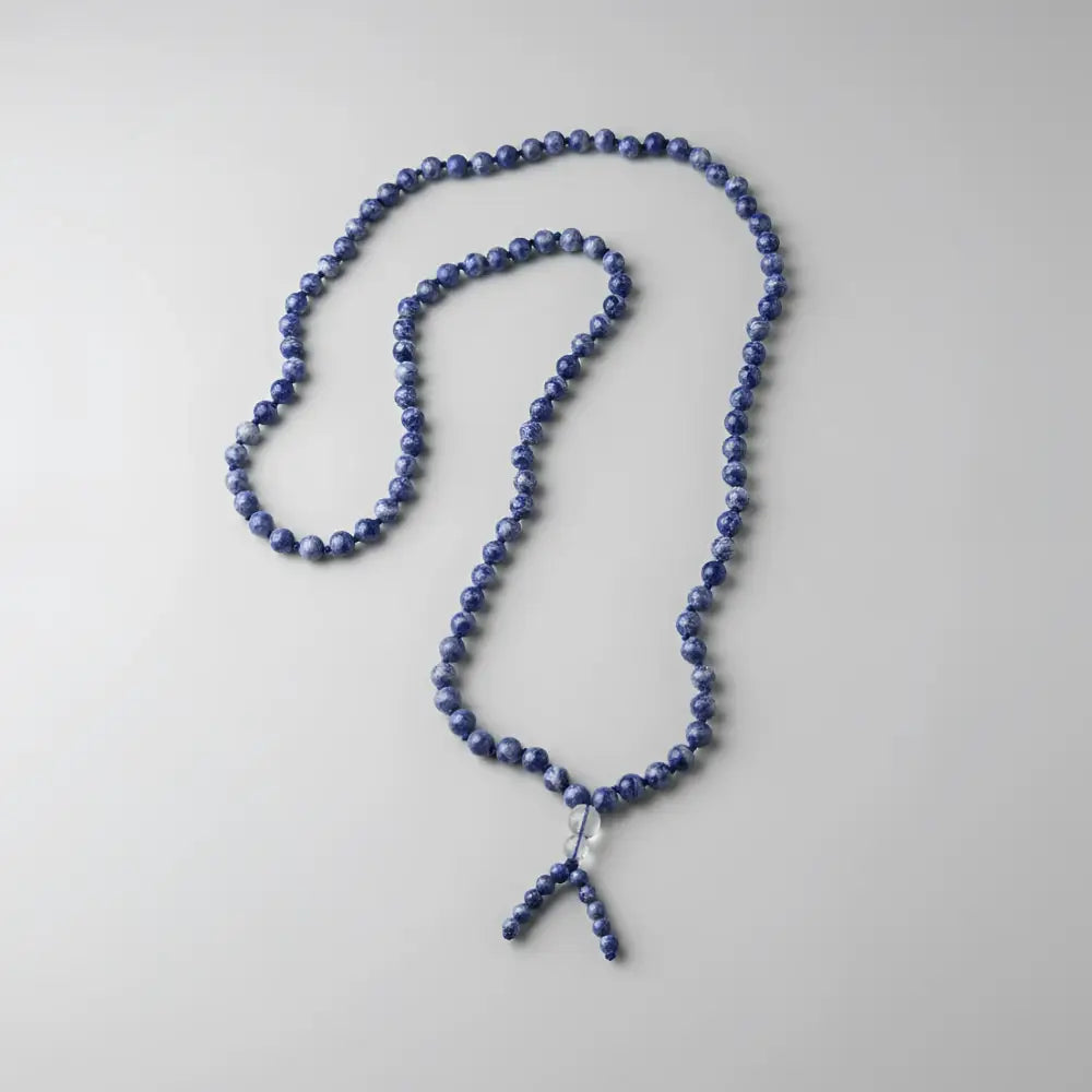 A delicate blue sodalite mala with 6 mm beads and clear crystal pendant perfect as a meditation companion for mantra chanting