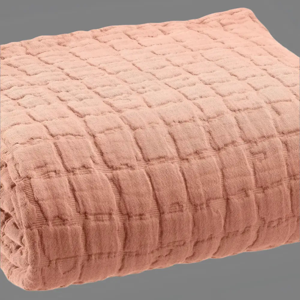 Soft peach-colored cotton lightweight quilt with a subtle grid pattern, perfect king size bedding