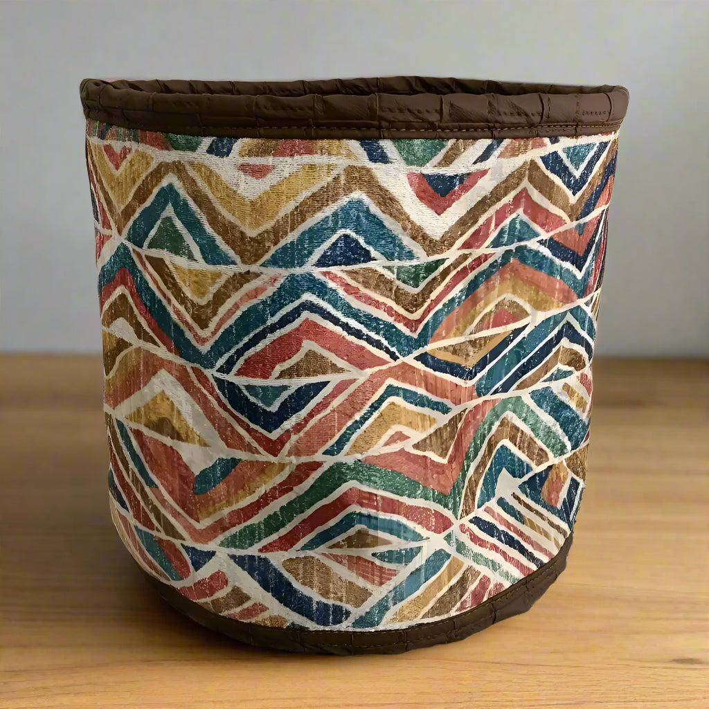 Colorful Turkish Rug Basket with geometric pattern and dark brown trim for plants