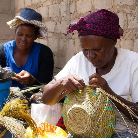 Two women demonstrating african basket weaving with natural fibers for wiki Tonga baskets