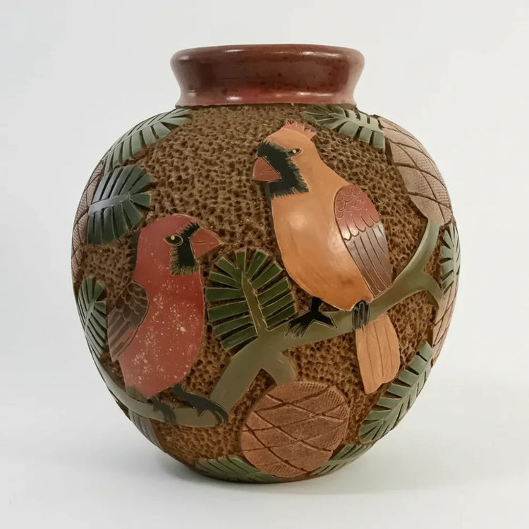 Ceramic vase with textured brown surface and embossed cardinals pine branches and pinecones