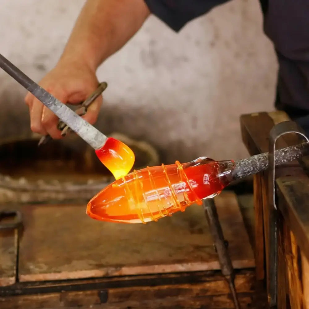glass blower forming hot glass object