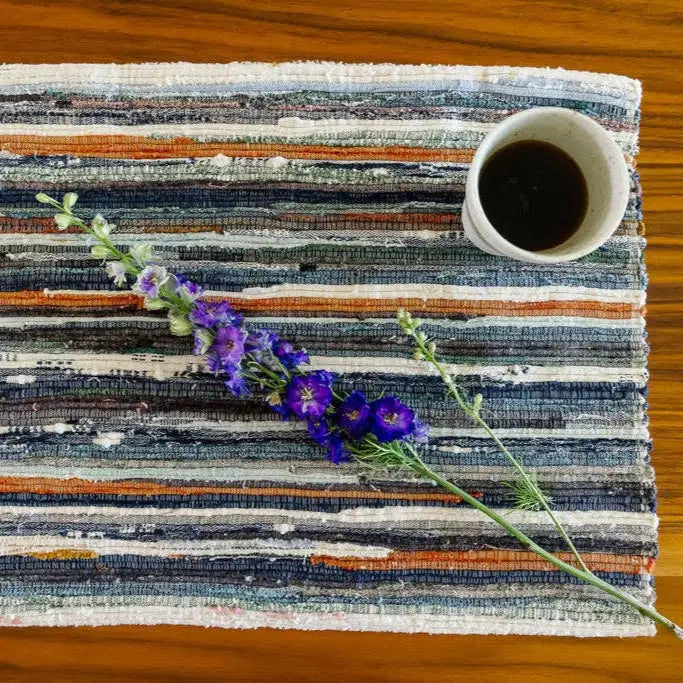 Colorful striped woven placemat with flower and coffee cup from Ethiopian upcycled linens