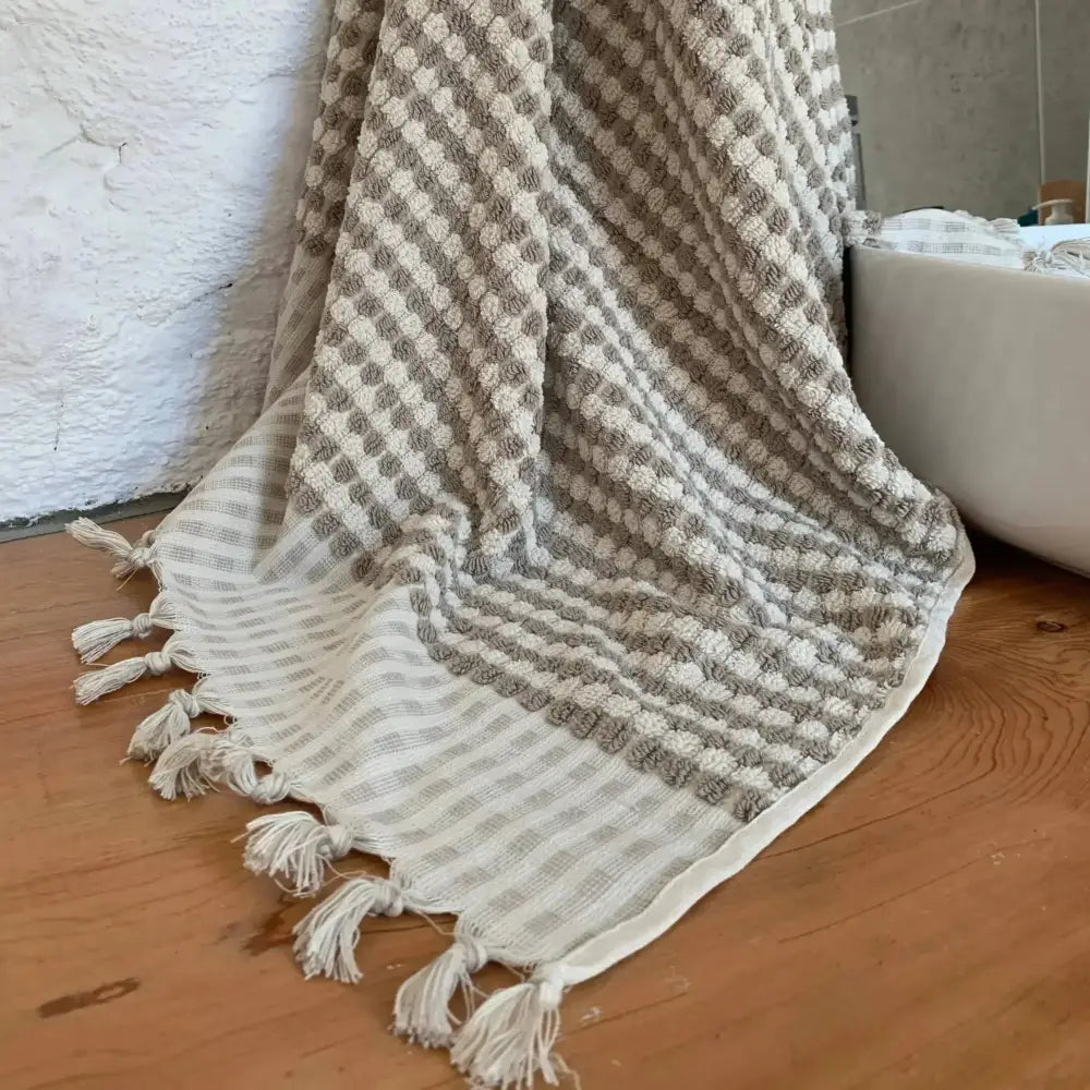 Colorful textured checkerboard Turkish Bath and Beach Towels stacked in a collection