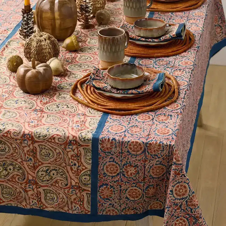 Fall-themed decor on a patterned reversible compass and paisley tablecloth from India
