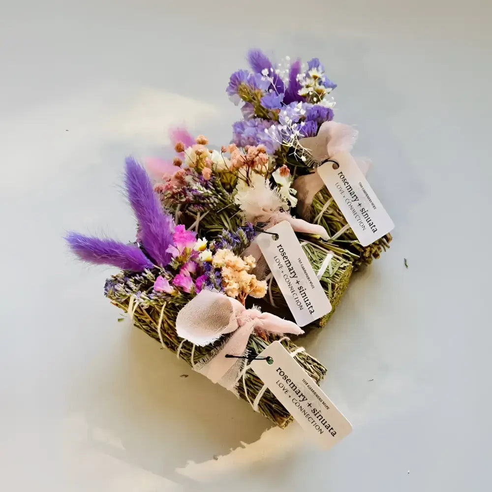 Artisan smudge sticks: dried herbs, flowers in twine, pink ribbons, tags