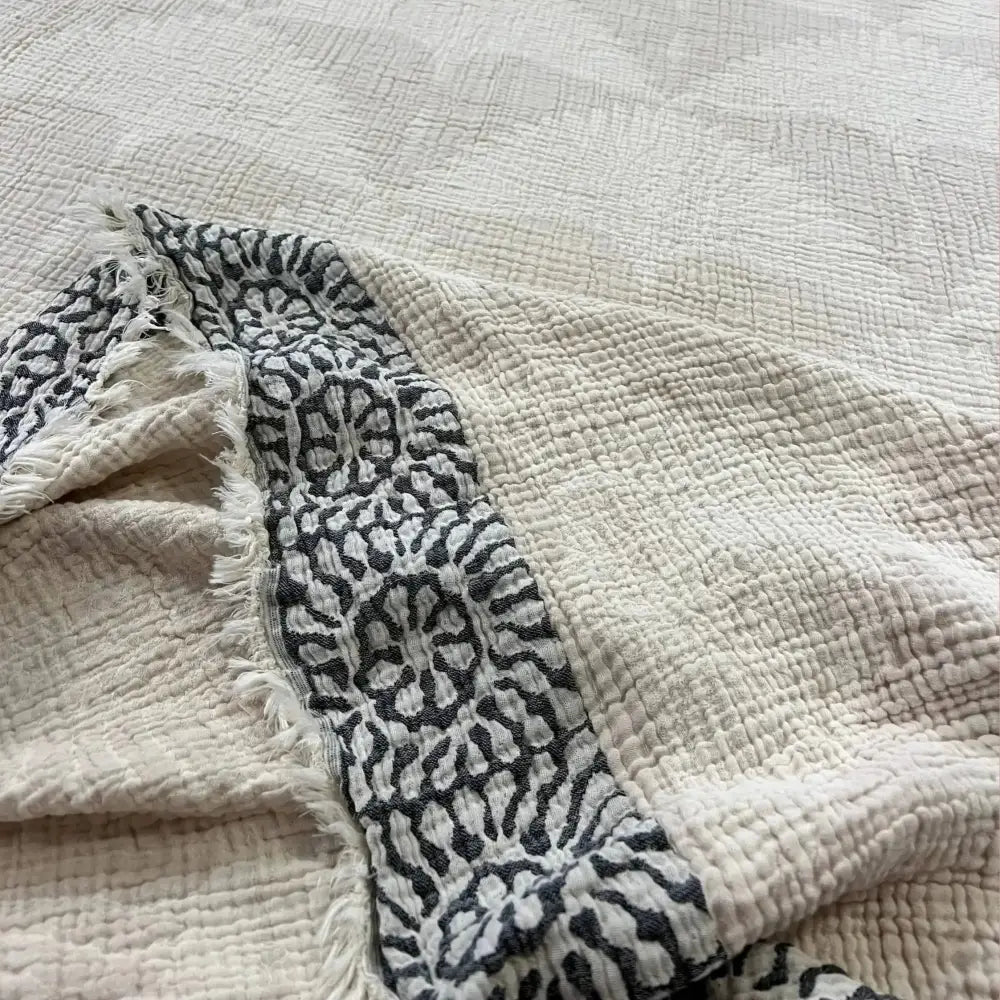 Soft textured white and gray Turkish Muslin throw blanket from the collection
