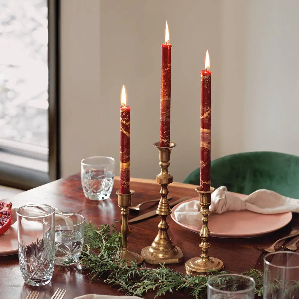 12’’ Decorative Taper Candles in red and gold on a table with candleholders and place setting