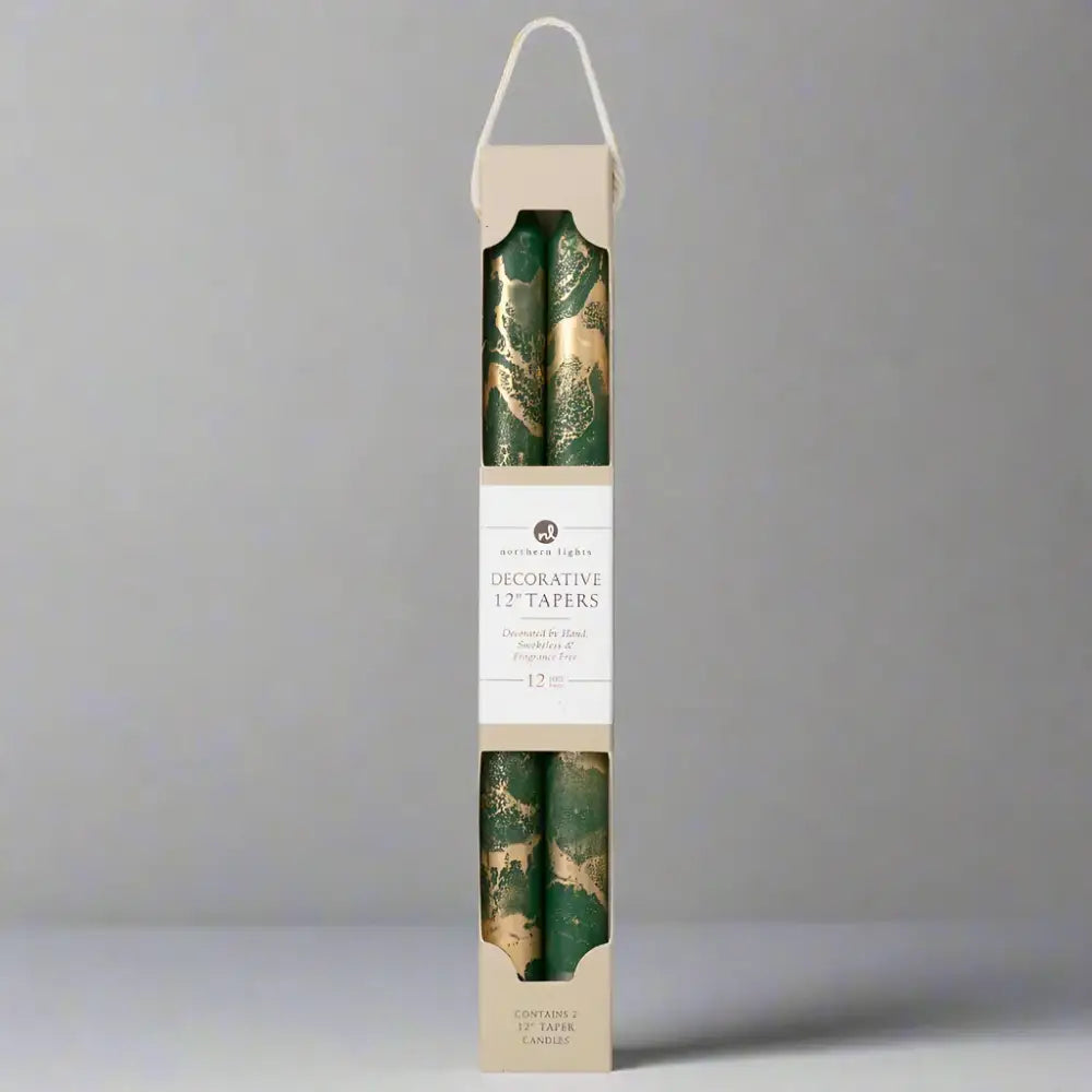 Pack of decorative candles with green and gold design in a cardboard box on a white background