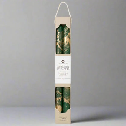 Pack of decorative candles with green and gold design in a cardboard box on a white background