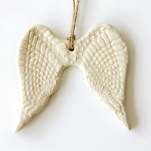 White ceramic angel wing ornament with twine hanger for year-round gifting