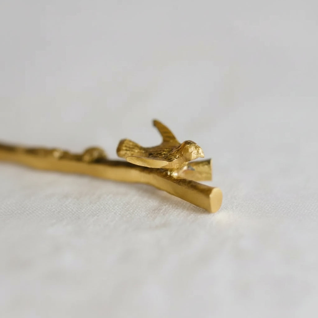 Gold bird-shaped brass hair clip with intricate details
