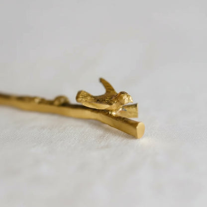 Gold bird-shaped brass hair clip with intricate details